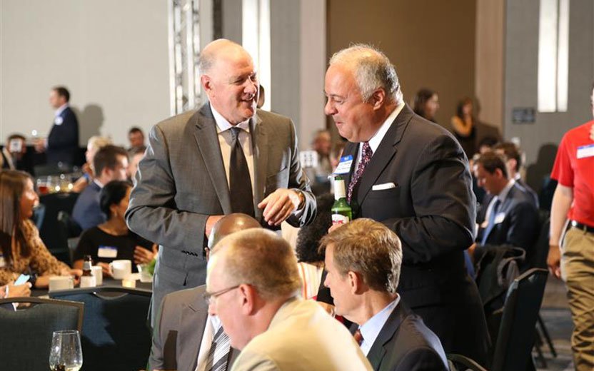 Advance Ohio Top Workplace 2020 two executives talking at an employee event