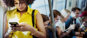 Young woman using a smartphone in a subway.